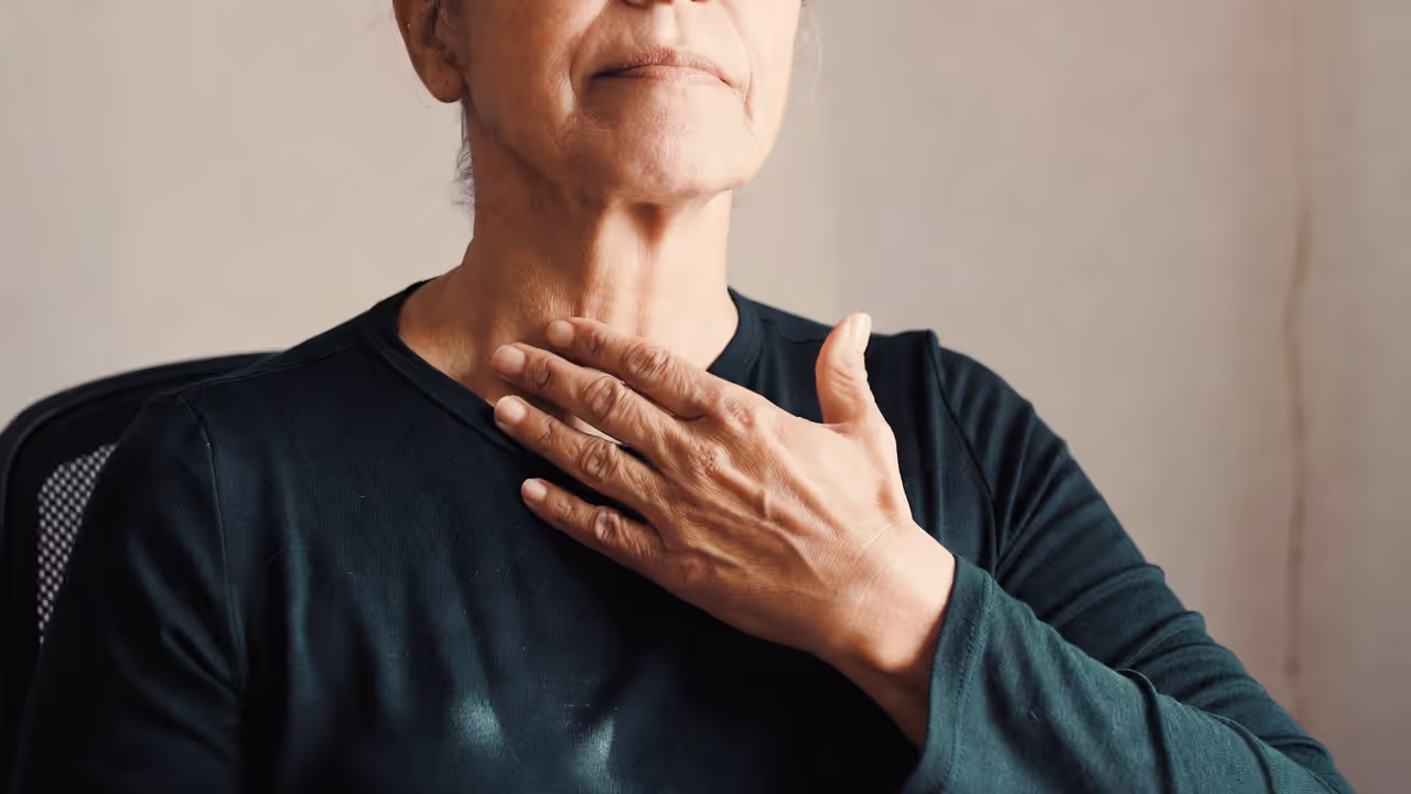 Adult experiencing physical discomfort associated with anxiety