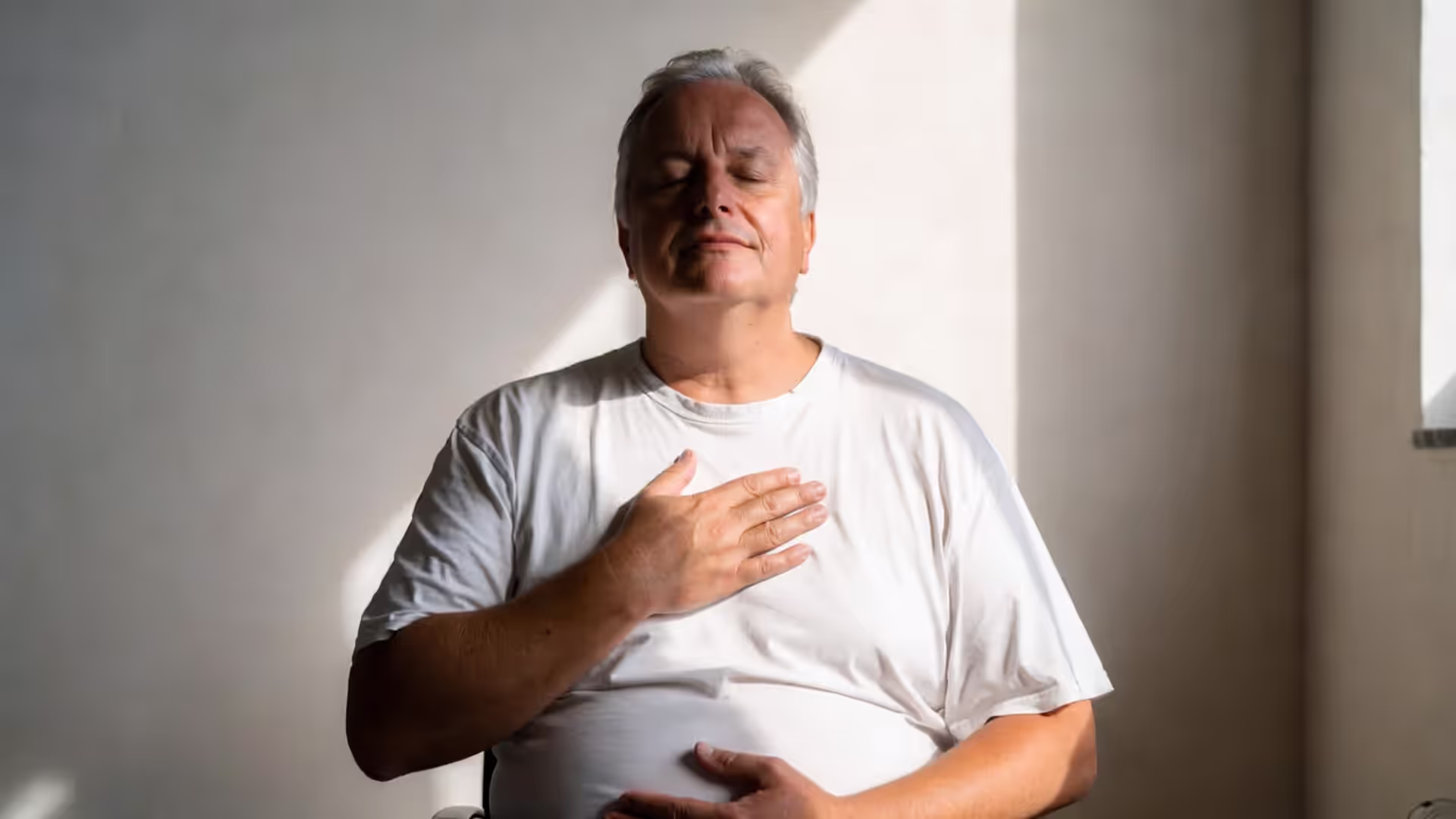 A person in a relaxed position with closed eyes, practicing relaxation